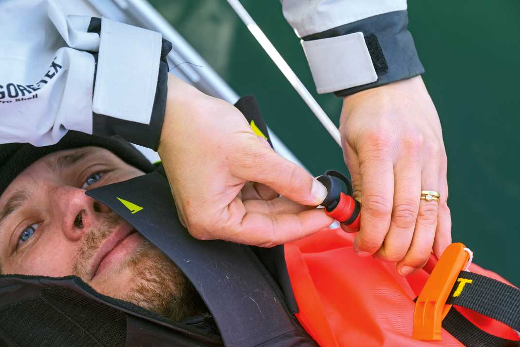 Let the air out: Back on deck, the inflated lifejacket gets in the way. That's why the first step is to deflate it