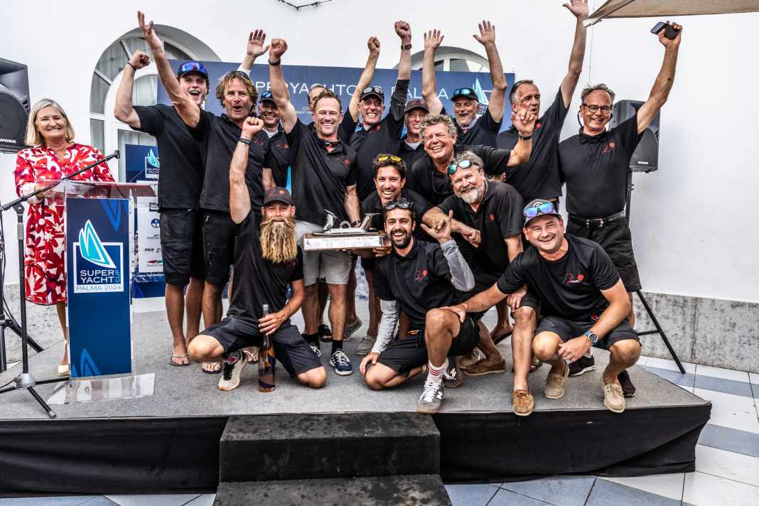 The crew of the Wally 80 "Rose" celebrates the title defence and is delighted with the "Big Bent Cleat" trophy. | photo: Sailing Energy / The Superyacht Cup