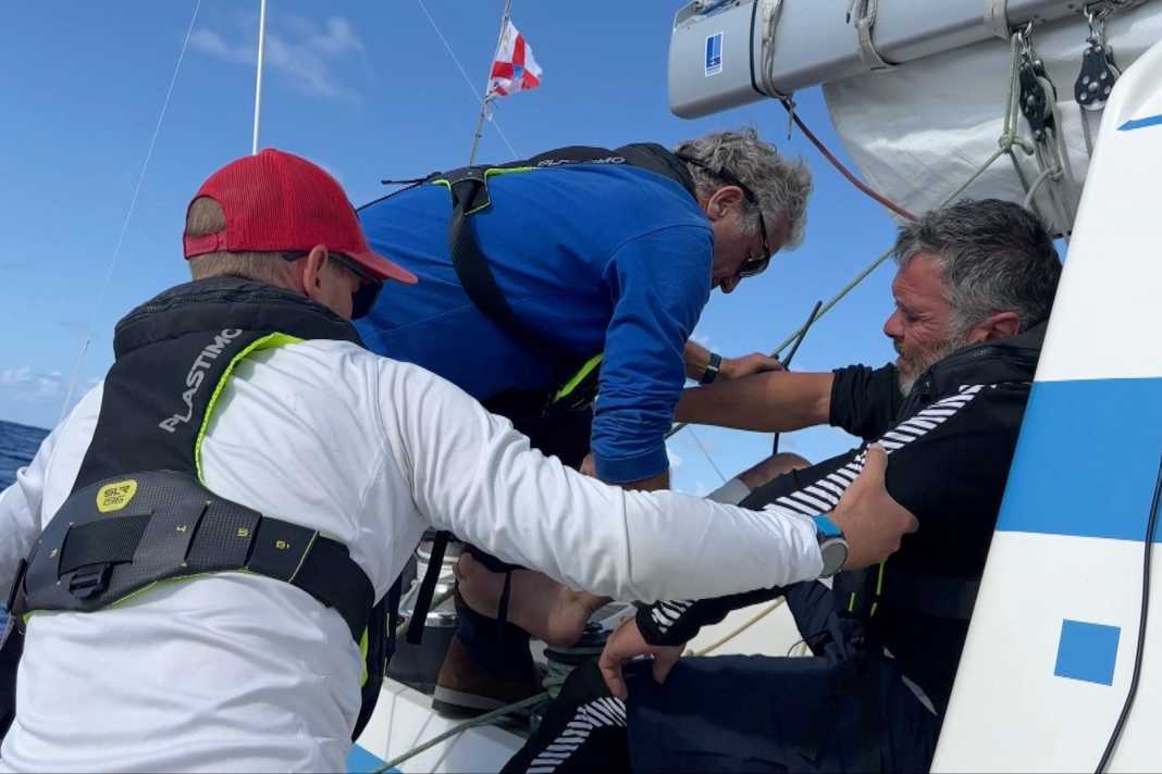 The injured crew member is brought on deck ...