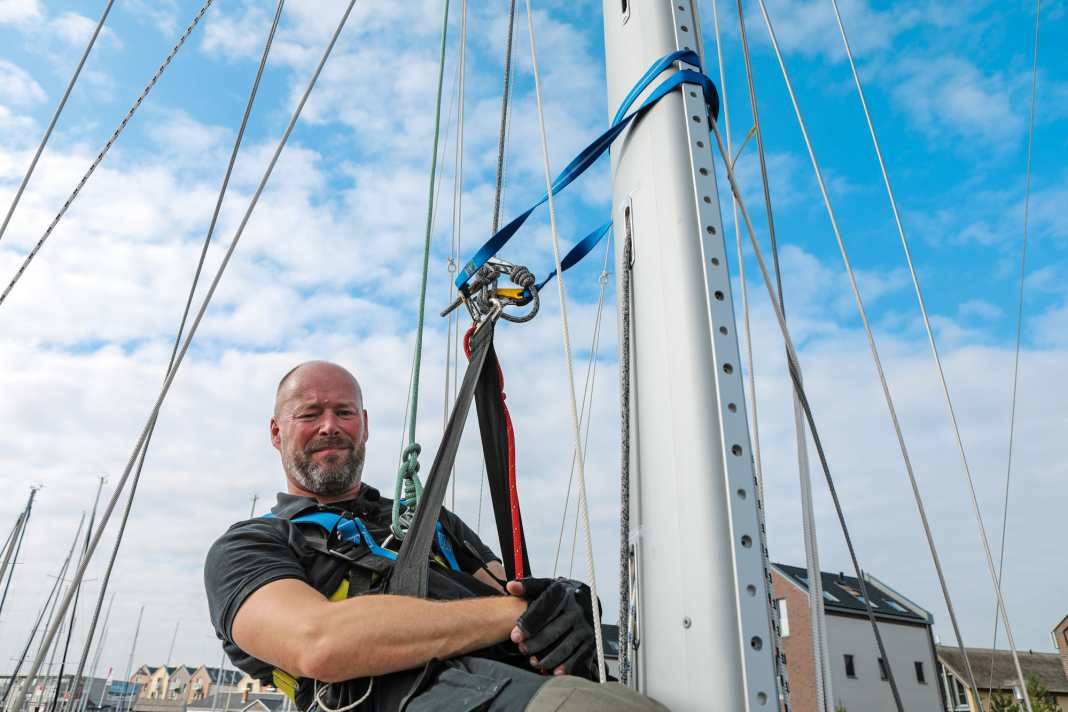 Strap or sling holds the person on the mast