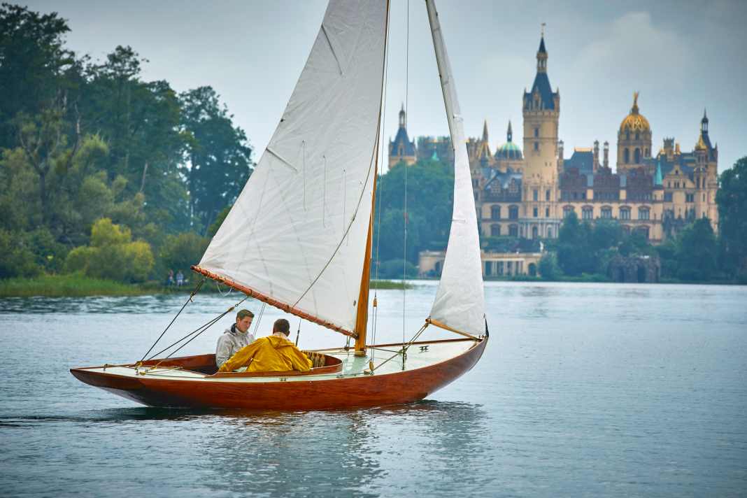 Franz Köhn at the helm of his Buzzard's Bay 15, christened "Therapie".