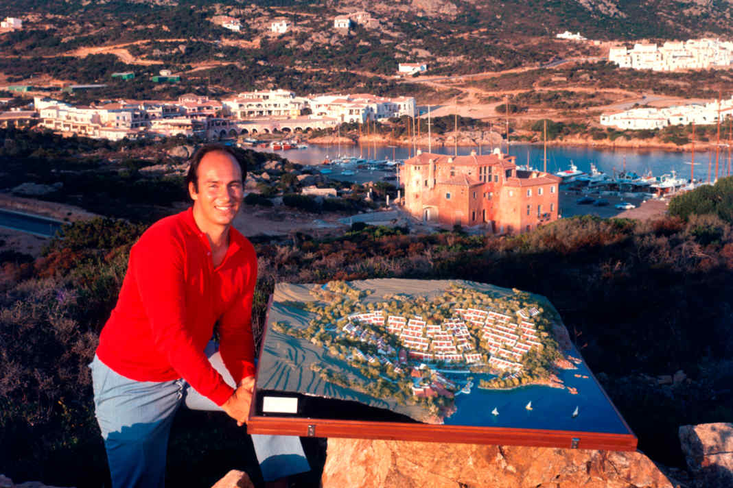 Prince Karim Aga Khan in 1960 on a hill above Porto Cervo, with the Yacht Club Costa Smeralda, which he co-founded, in the background.