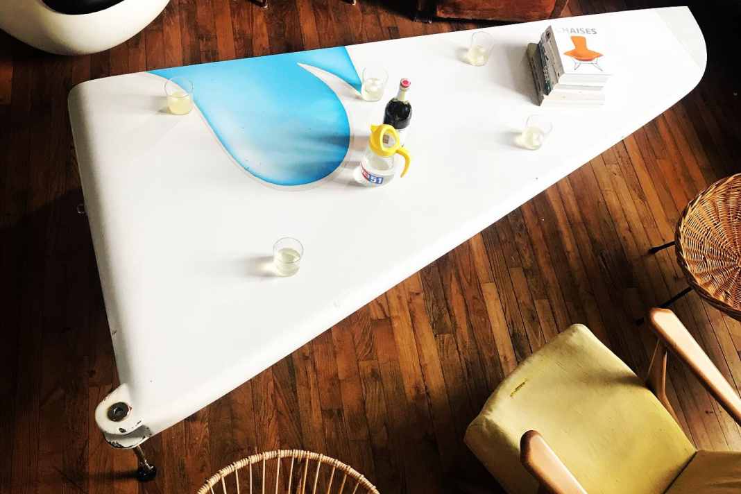 Cheers! This table used to be a part of the fuselage, more precisely the prow of "Geronimo".