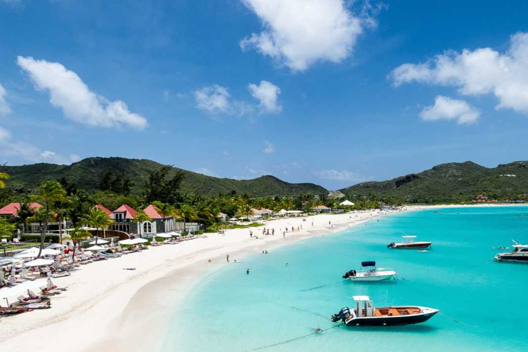A real dream beach plus boats bobbing in front of it.