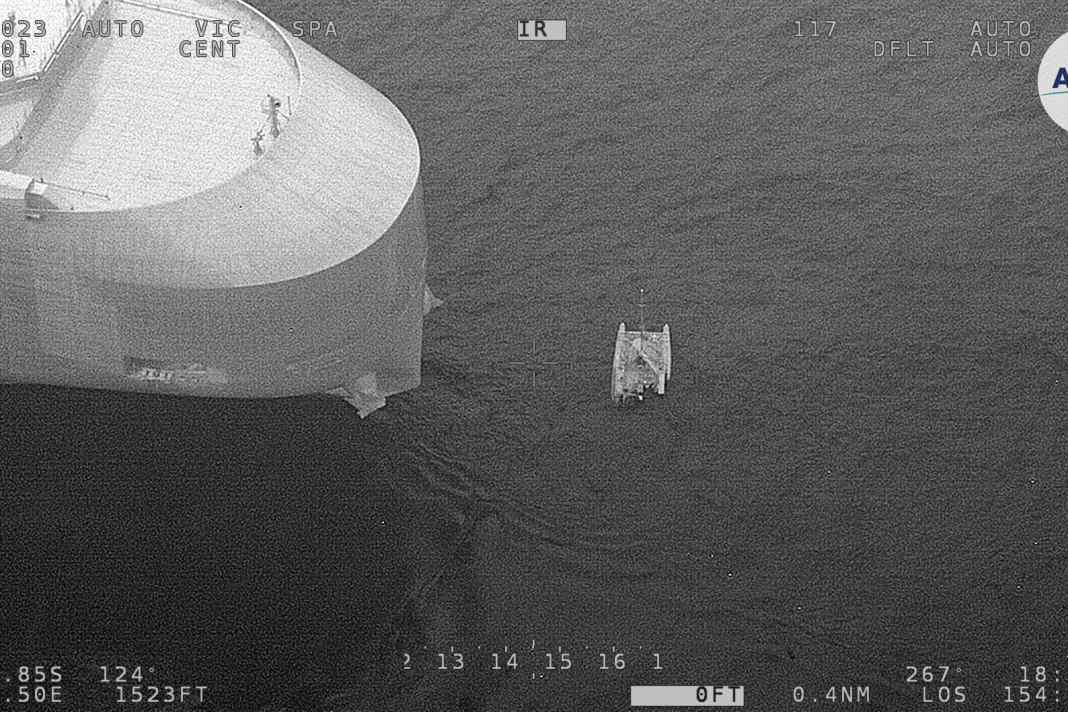 The catamaran off the bow of the freighter
