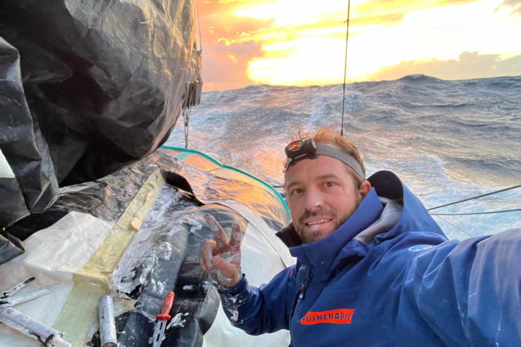 Sam Goodchild has started trying to repair his mainsail, which was torn at the third reef.