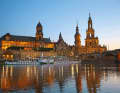 Golden glow at Blue Hour: view of the Old Town skyline from the Elbe meadows. From the left in the picture: the Ständehaus, built in imperial times, the Georgentor with the neighbouring Residenzschloss (both from the 16th century) and the baroque Hofkirche church