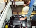 Der am Kran hängende Motor wird problemlos auf die vorbereiteten Fundamente gestellt. Eine Taschenlampe bringt Licht ins Dunkel