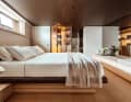 Owner's cabin: warm light streams out of the wardrobe through ribbed glass doors. Mirrors and wooden louvres extend the length of the room