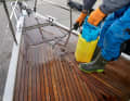 Step 3 - Spraying: The deck is treated with Semco's special cleaner, which gives the wood a very dark colour for a short time