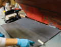 Everything has two sides: Once the resin and hardener have been mixed accurately and well, one side of the Coosa panels is coated evenly and thoroughly with the roller.