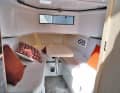 Bow seating area convertible into a berth