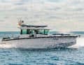 The XC Cross Cabin with two Mercury V6 engines and a stand-up paddleboard on the roof. The image is reminiscent of Axopar's Explorer DNA