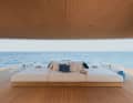 Convertible: the large upholstered island of the beach club can be moved to the side to reveal or conceal the plunge pool positioned below it