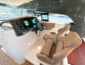 The stern area of the catamaran with a large dining table and space for at least eight people