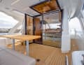 The galley and cockpit can be connected via a hinged window. A sofa provides comfort in the cockpit.