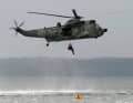 The mine divers are winched up out of the water
