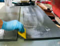 For the other side, the resin-hardener mixture is thickened with a special filler and the finished mixture is then spread over the entire surface of the panels using a spatula