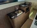 The galley was integrated on board the narrow catamaran opposite the steering position