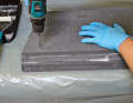 To increase the contact pressure, the "sandwich" of panels and adhesive is screwed together with long Spax screws during curing