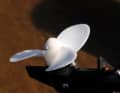 The plastic propeller is secured with a screw at right angles to the hub