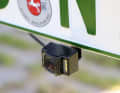 The camera is glued to a bracket behind the licence plate. It must be positioned in the centre