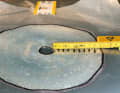 Sand the stock: Sand a stock twelve times the thickness of the laminate around the hole, in this case about ten centimetres. Transfer the outline to a sheet of foil and mark the size of the fibreglass patches on it