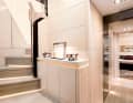 Living in white on the lower deck: the companionway connects the corridor to the cabins with the helm station on the main deck