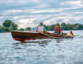 Owner Menno Wolters at the helm of his "Nixe" during a trip on the Dove-Elbe near Hamburg