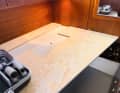 We use a 20 mm thick plywood panel made of maritime pine as the new base plate for the double bed. The necessary cut-outs, in our case for the inspection hatch to the tank, are sawn out with a jigsaw. Then bevel the panel to suit the conditions and fix it in place with 4 mm screws