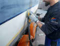 Step 2: All gelcoat surfaces are sanded with an eccentric sanding machine until the surface looks matt