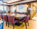 Dining area: All tables and cupboards come from Conrad's wood workshop, chairs and sofas were selected by the CEO. The corridor leads into the owner's flat