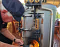Thomas Schmid throws in a wood briquette. In an instant, the pressure in the boiler rises and the boat speeds up