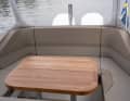 The large and well-made teak table serves as a cockpit table in the rear of the T9