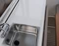A wet bar with sink and space for a cooker is located between the cockpit and the helm position