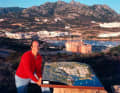 Prince Karim Aga Khan 1960 on a hill above Porto Cervo, in the background the Yacht Club Costa Smeralda which he co-founded