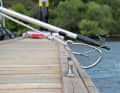 By simultaneously pressing with the tip of the boat hook and pulling on the knotted line, the carabiner opens and ...