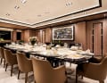 The ebony dining table for 16 people is adorned with an onyx stone in the centre