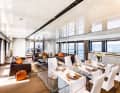 Flooded with light: Floor-to-ceiling windows and the orange accent typical of Wider characterise the large saloon on the main deck