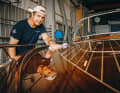 Mirror-like craftsmanship: 18 layers of clear varnish protect the mahogany wood. Boat builder Niklas Jacobsson polishes until the surface shines perfectly