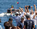 Spectators cheer the participants