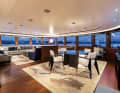Upper deck saloon: Numerous seating areas invite you to relax. A large TV extends from the centre chest of drawers