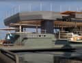 Behind the slats of the main deck, the bar and lounge are cabana-style, with bamboo walls, velvet, embroidery and a lounge island on the crane.