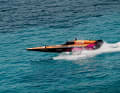 The RacingBirds fly over the turquoise blue water.