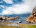 Weather approaching: small boats in the northern arch of Svenner. The meadow behind the beach is the "campsite" of the water hikers who come to the island