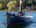Stephanie Hylton at the helm and steam engine of her almost 130-year-old launch "Uno"