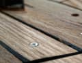 Screws that are not recessed deep enough are also exposed during sanding. They damage the paper and have to be removed. If they do not come loose, a hammer blow or heating with a soldering iron will help