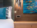 Subtle splashes of colour: only cushions and the artwork of Guernsey-based painter Valerie Travers provide accents.