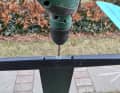 Carefully pre-drill with the thin drill bit. If the screw head does not fall off, drill again with the thicker metal drill bit