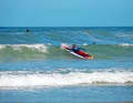 In extremely choppy water within the surf zone, lying down is often the only thing that helps. The paddle lies under the body and you paddle with the bow out towards the wave with your hands.